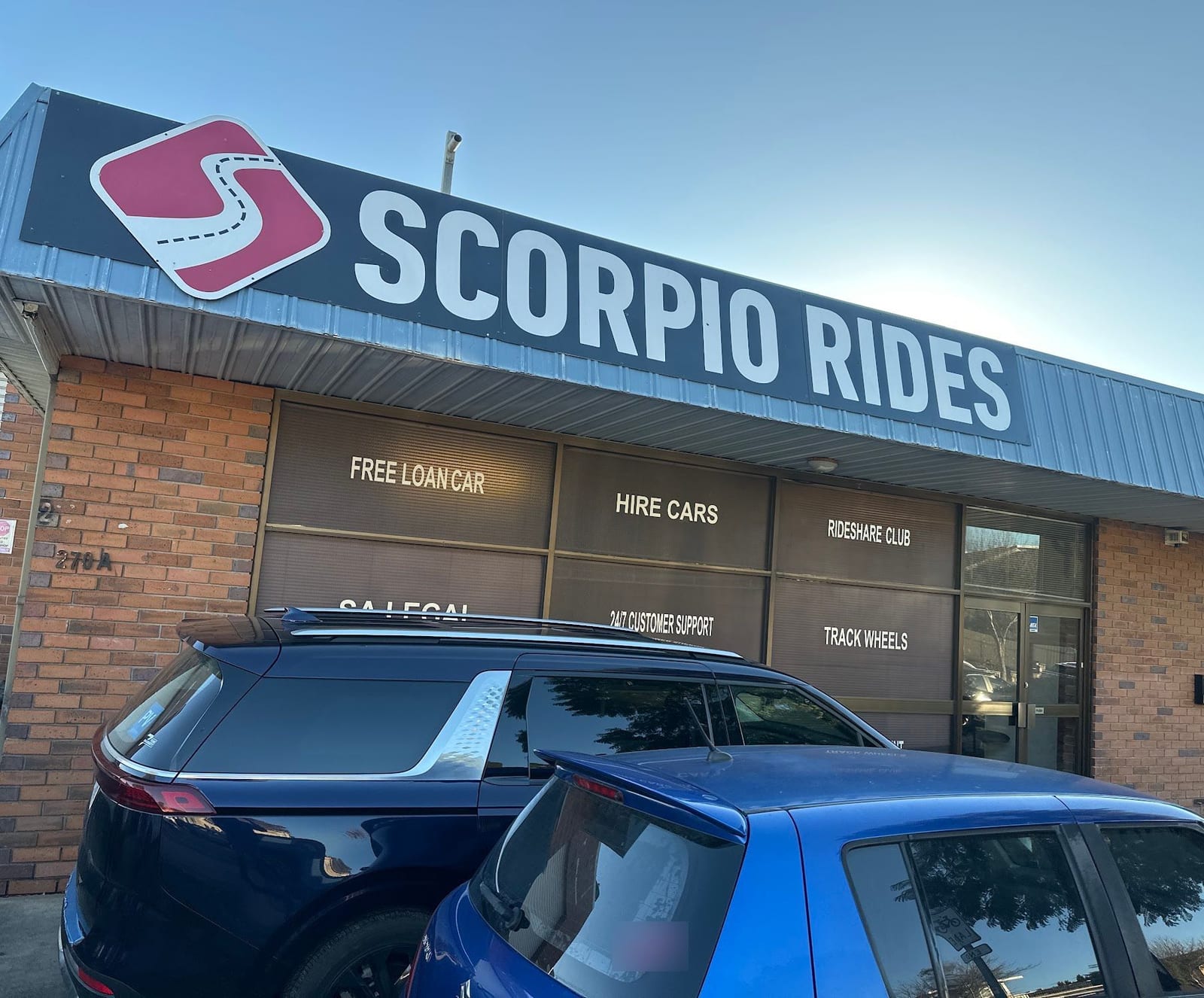 The Scorpio Rides shopfront on Prospect Road, with two cars parked out the front
